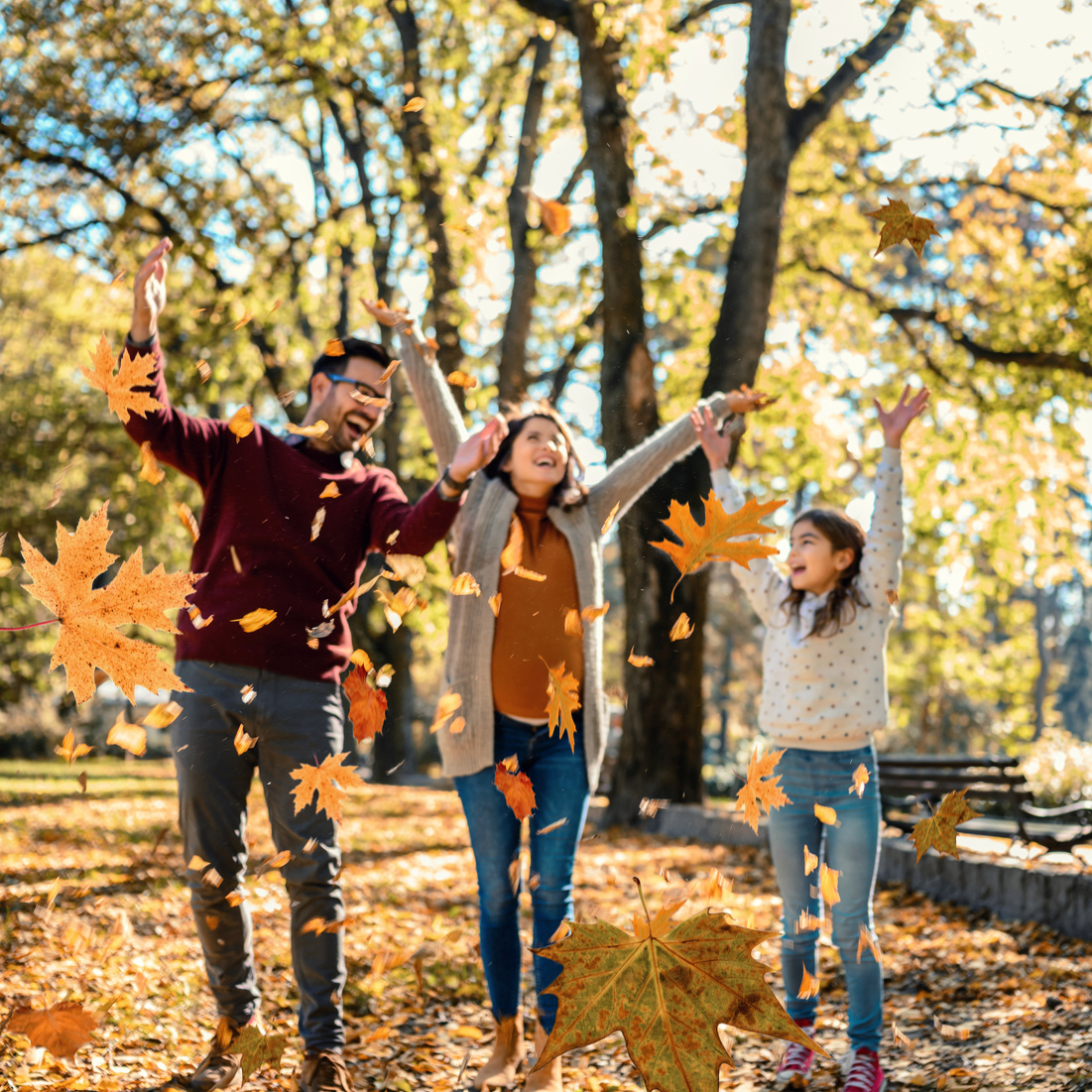 Family throwing leaves